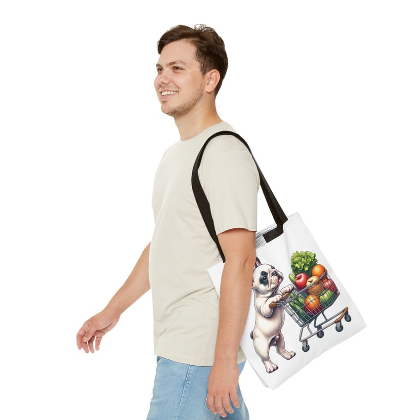 Young man with playful puppy tote bag, smiling and walking casually in a light background.