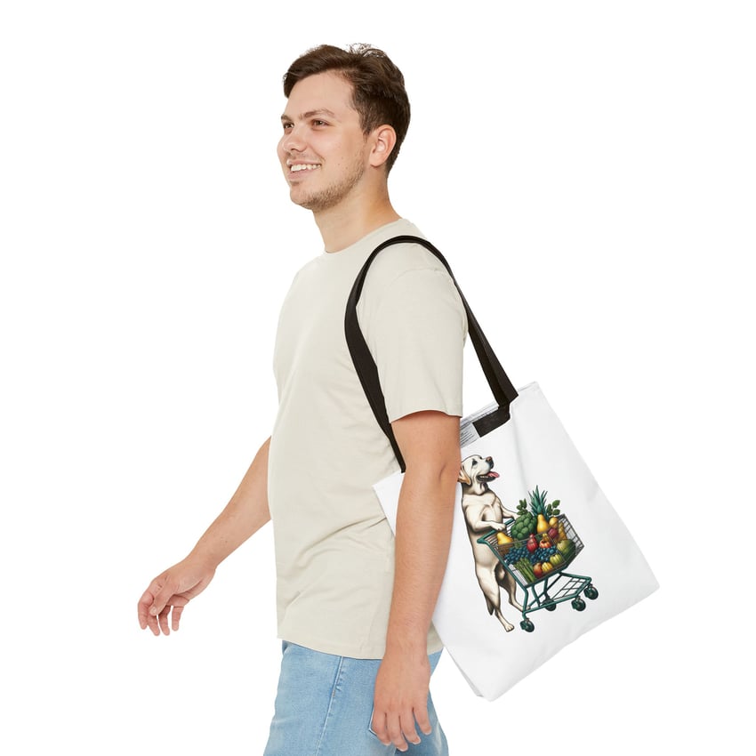 Young man smiling, walking with a cartoon dog tote bag on a white background.