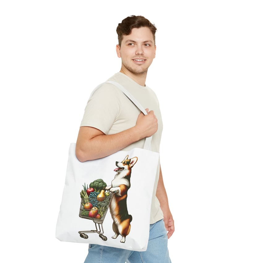 Person strolling with corgi tote bag featuring vibrant groceries, beige t-shirt, and blue jeans.