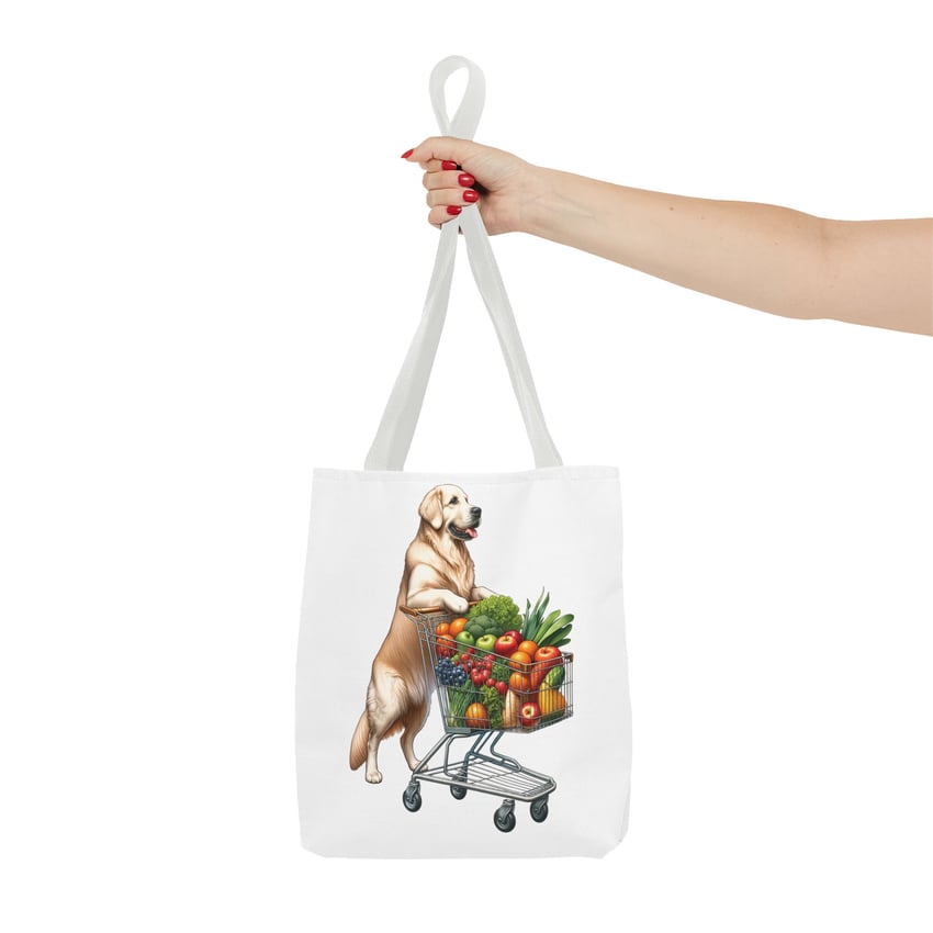 Eco-friendly tote with cheerful dog and produce design, held by manicured red-nailed hand.