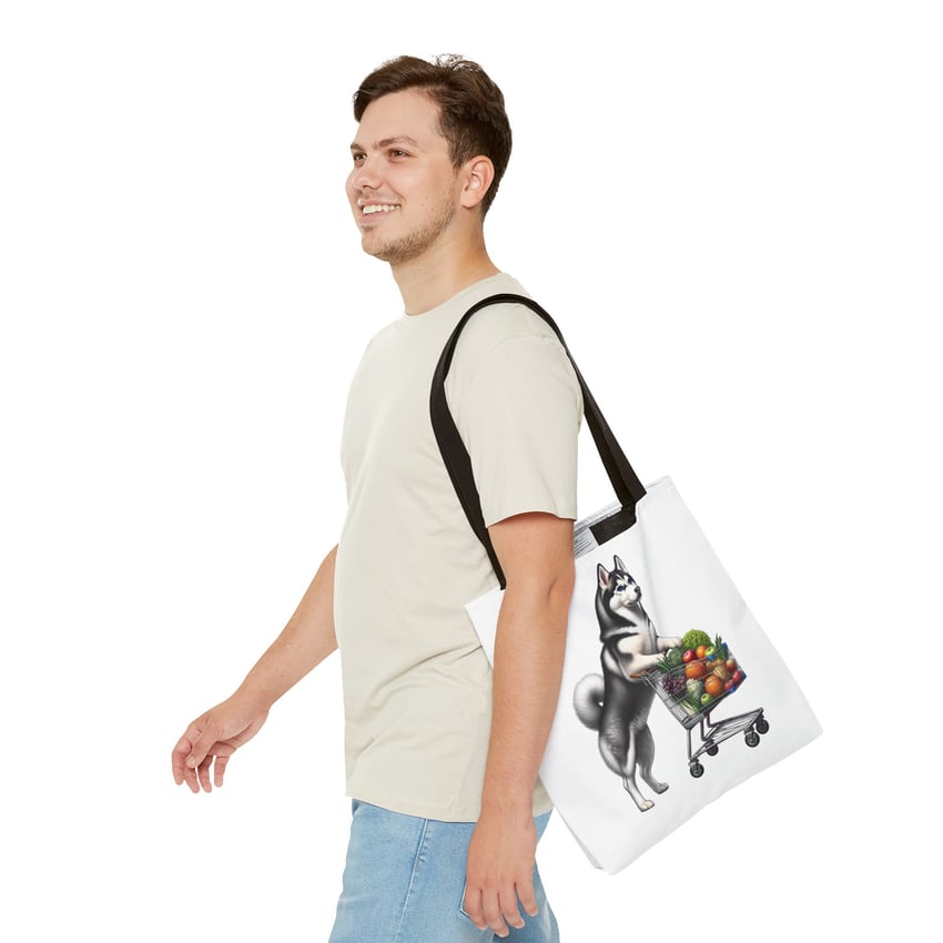 Smiling person with a fun cartoon husky tote bag and casual outfit.