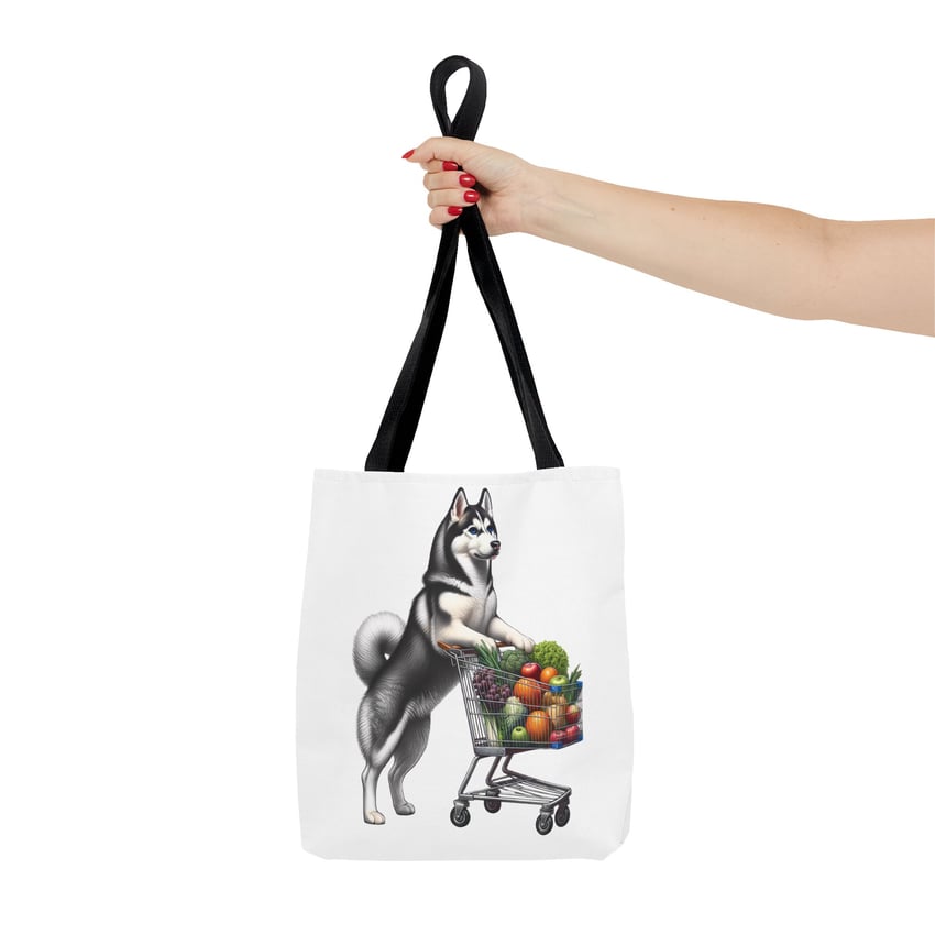 Anthropomorphic Siberian Husky tote bag with colorful cart illustration, held by red-nailed hand.
