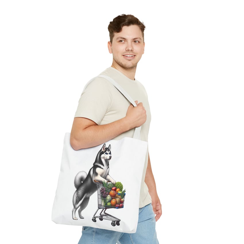 Young man with curly hair and whimsical Husky tote bag, casual beige and blue outfit.