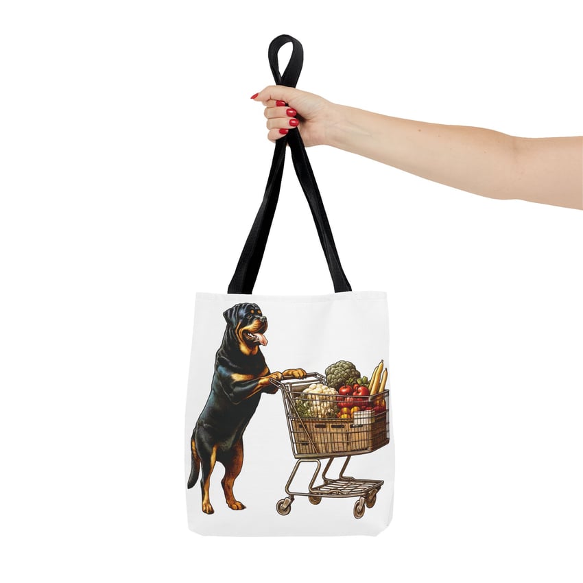 Tote bag with Rottweiler pushing grocery cart, held by hand with red nails.